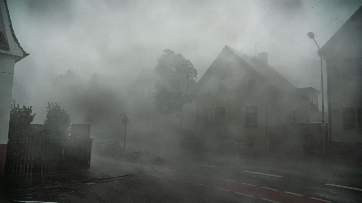 Nichts mehr zu sehen: Ein starkes Gewitter mit Sturmböen zieht durch die Straßen der südhessischen Stadt Langen. Foto: Frank Rumpenhorst