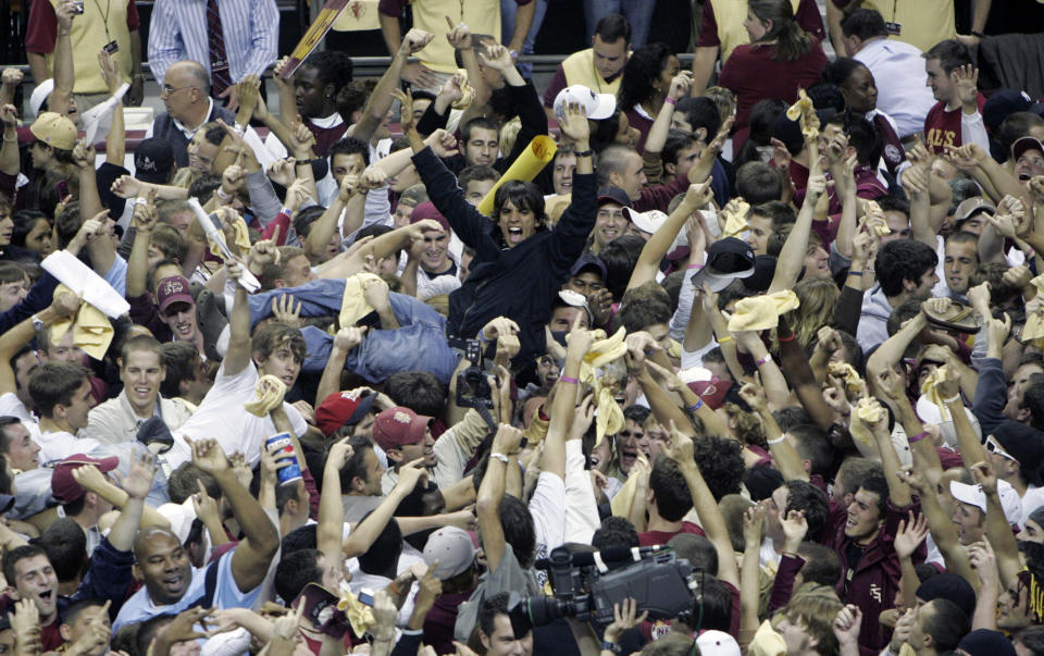 FILE - Florida State fans storm the court following the Seminoles 70-66 upset win over Florida, Sunday, Dec. 3, 2006, in Tallahassee, Fla. Recent incidents in college basketball have underscored the potential dangers that come from jubilant fans storming the court after the game comes to an end. Finding a solution is proving to be a challenge. (AP Photo/Phil Coale)