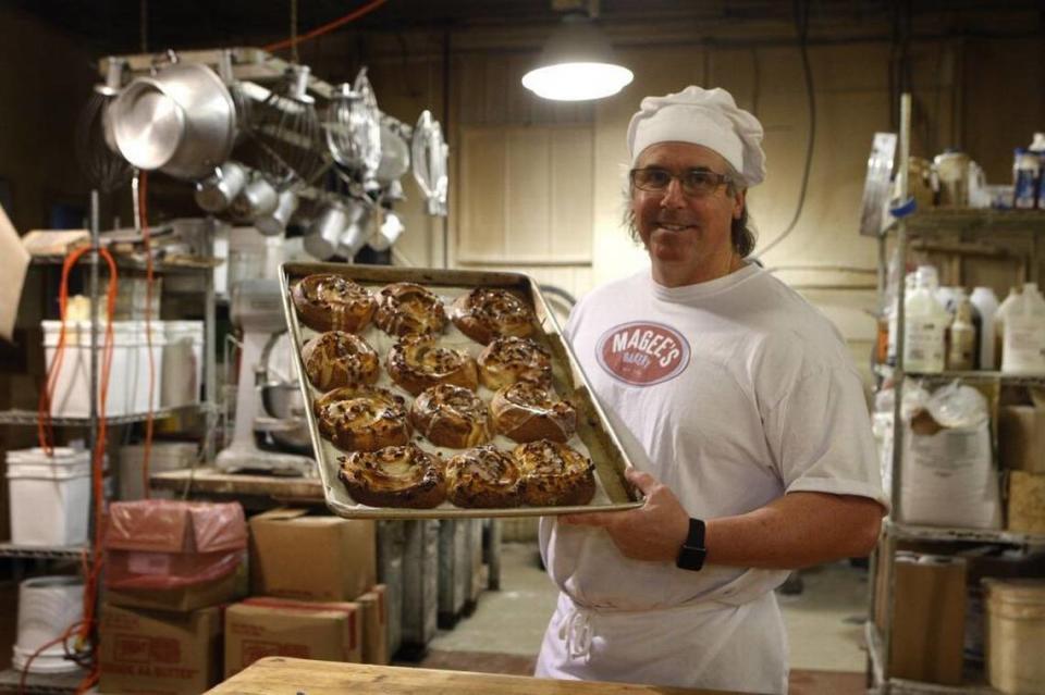 Co-owner Greg Higgins holds a tray of pecan danish in the kitchen at Magee’s Bakery at 726 East Main Street in Lexington in 2015.