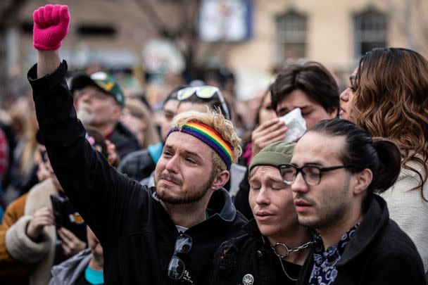 PHOTO: Mourners attend a ceremony where a rainbow flag was draped over the City Hall building in honor of the victims of a shooting at Club Q in Colorado Springs, Colo., Nov. 23, 2022. (Chet Strange/Getty Images)