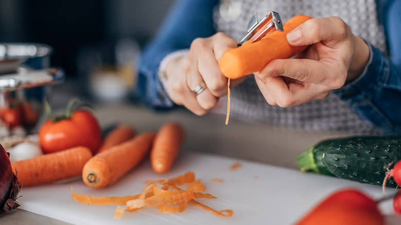 person slicing carrots with mandoline