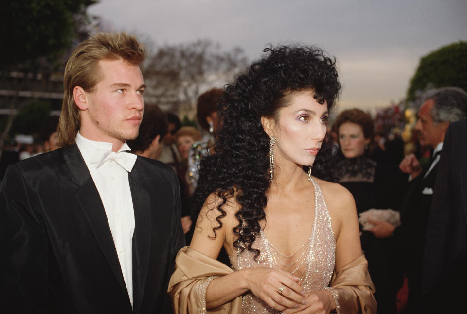 American actors Cher and Val Kilmer arrive at the 56th Academy Awards, where Cher is nominated for Best Supporting Actress in Silkwood. (Photo by Bill Nation/Sygma via Getty Images)