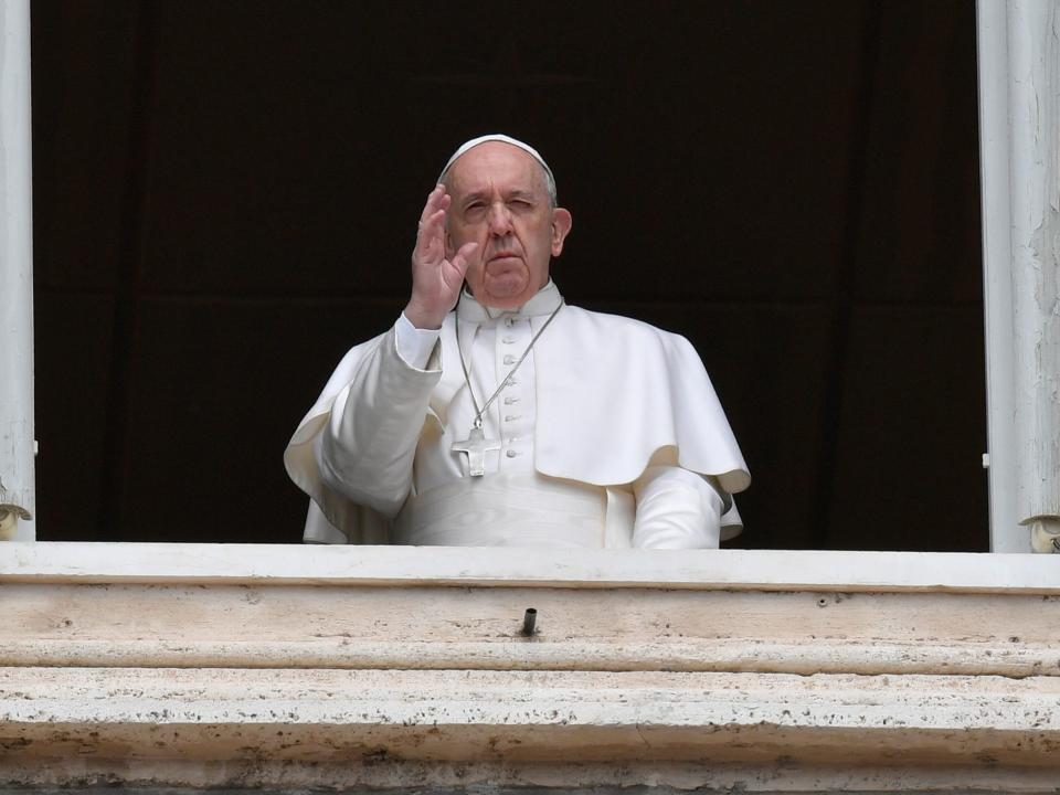 Pope Francis waves from the window of the Apostolic Palace on Easter Monday at the Vatican April 13, 2020.  Vatican Media/­Handout via REUTERS