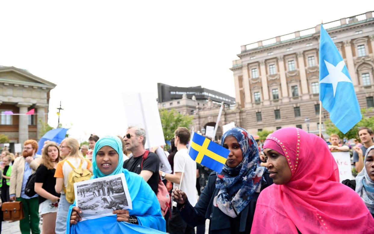 Protesters gather outside parliament in 2016 to demonstrate against tougher new asylum policies - AP