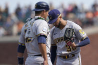 Milwaukee Brewers pitcher Devin Williams, right, meets on the mound with catcher Luke Maile during the eighth inning of the team's baseball game against the San Francisco Giants in San Francisco, Thursday, Sept. 2, 2021. (AP Photo/Jeff Chiu)