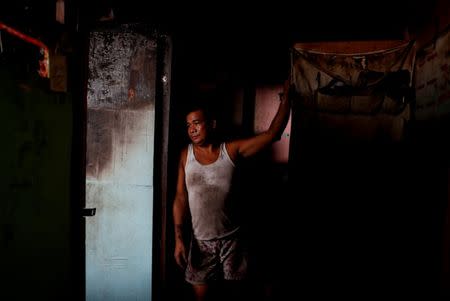 A man stands at the entrance of his partially damaged house after a fire at a residential district in Pasig, Metro Manila, Philippines, May 5, 2018. REUTERS/Erik De Castro
