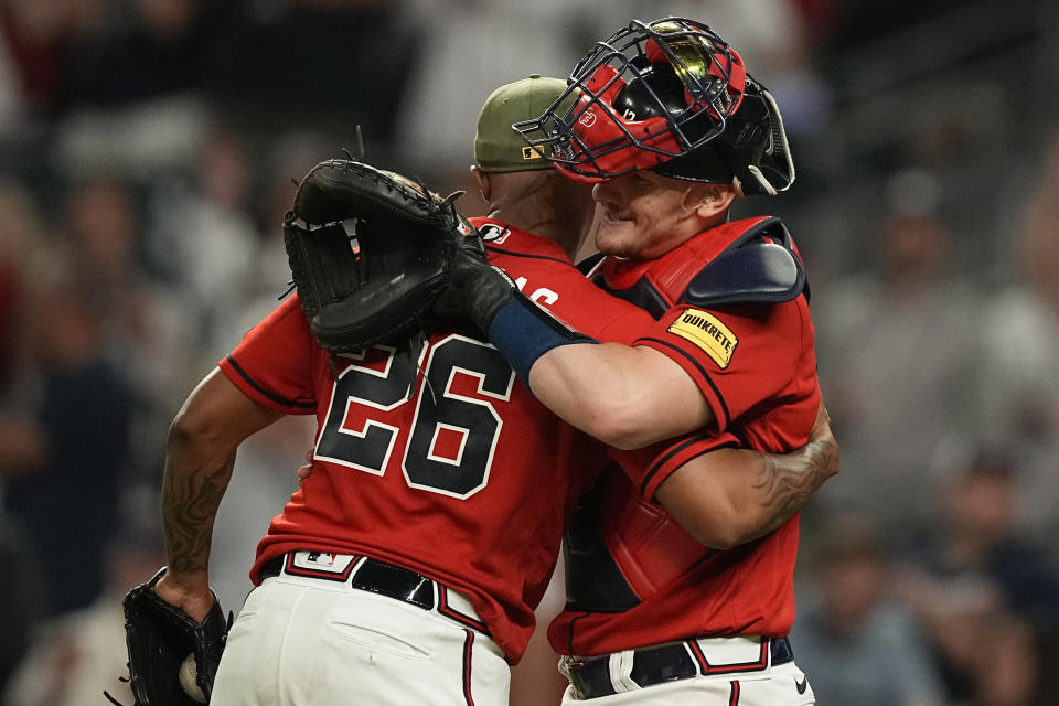 Atlanta Braves relief pitcher Raisel Iglesias (26) celebrates with catcher Sean Murphy after the team's win against the Seattle Mariners in a baseball game Friday, May 19, 2023, in Atlanta. (AP Photo/Brynn Anderson)