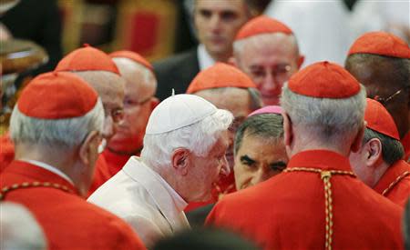 Pope Emeritus Benedict XVI is greeted by Cardinals as he arrives to attend a consistory ceremony in Saint Peter's Basilica at the Vatican February 22, 2014. REUTERS/Max Rossi