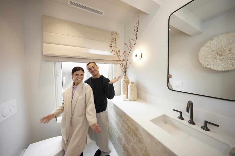 Steph and Gian pose in their downstair bathroom.