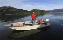 Trevor Amos stands in his fishing boat with a freshly killed seal on the Douglas Channel, in northern British Columbia near to where Enbridge Inc plans to build its Northern Gateway pipeline terminal facility April 13, 2014. REUTERS/Julie Gordon