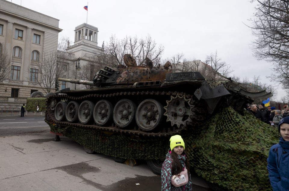 CORRECTS DATE---The wreck of a Russian T-72 tank destroyed on the approach to Kyiv is placed in front of the Russian Embassy to mark the first anniversary of Russia's full-scale invasion of Ukraine, in Berlin, Germany, Friday, Feb. 24, 2023. (AP Photo/Markus Schreiber)