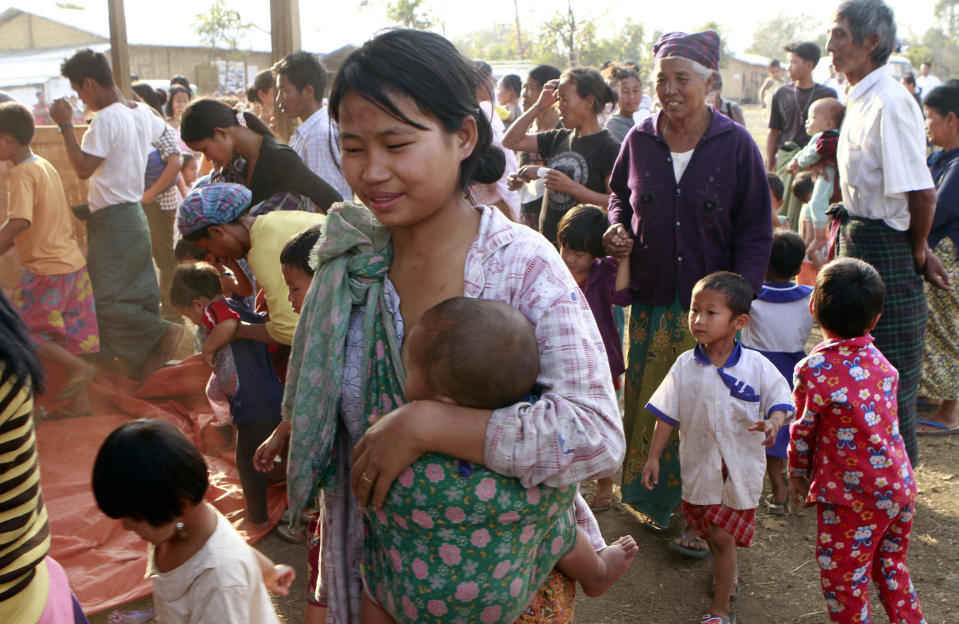 In this Wednesday, Feb. 22, 2012, photo, Myanmar refugees in Kachin State gather near their refugee camp in Myitkyina, Kachin state, northern Myanmar. A human rights group says the governments in Myanmar and China are failing to stop the brutal trafficking of young women from the conflict-ridden Kachin region for sexual slavery. (AP Photo/Khin Maung Win)