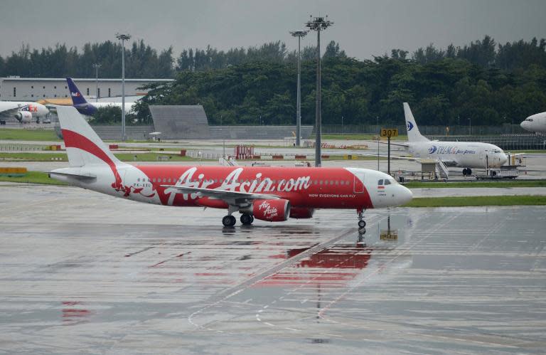 An AirAsia plane taxis on the tarmac after landing at Changi international airport in Singapore, on December 29, 2014