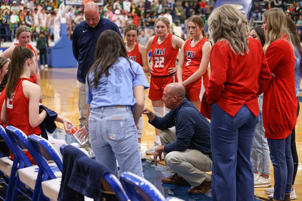 Jim Ned's girl's basketball head coach Hunter Cooley coaches him team before the final quarter against Idalou in the Region I-3A semifinal girls basketball quarterfinal game, Friday, Feb. 24, 2023, at Tiger Pit in Wolfforth.
