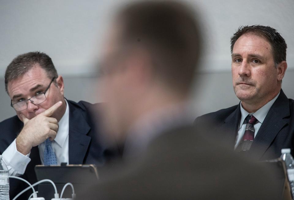 Former Louisville Metro Police detective Myles Cosgrove, right, sat with his attorney Scott Miller, left, while Andrew Meyer of the Louisville Metro Police Professional Standards unit testified during a police merit board hearing. Nov. 9, 2021