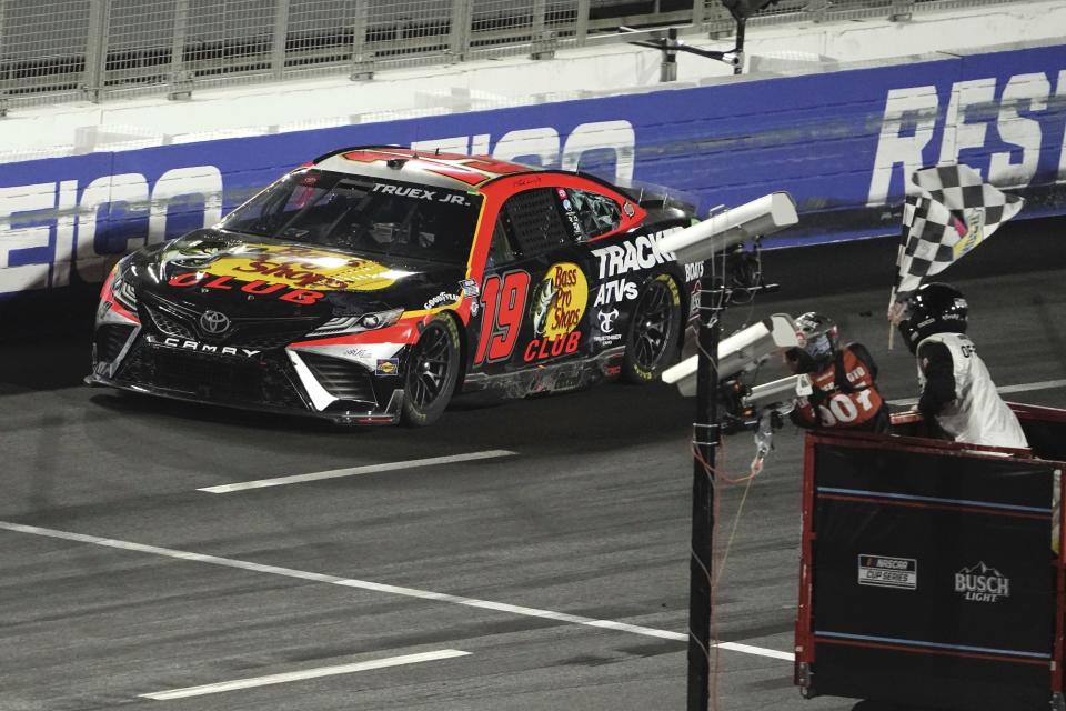 NASCAR Cup Series driver Martin Truex Jr. (19) takes the checkers flag to win the Busch Light Clash NASCAR exhibition auto race at Los Angeles Memorial Coliseum Sunday, Feb. 5, 2023, in Los Angeles. (AP Photo/Mark J. Terrill)