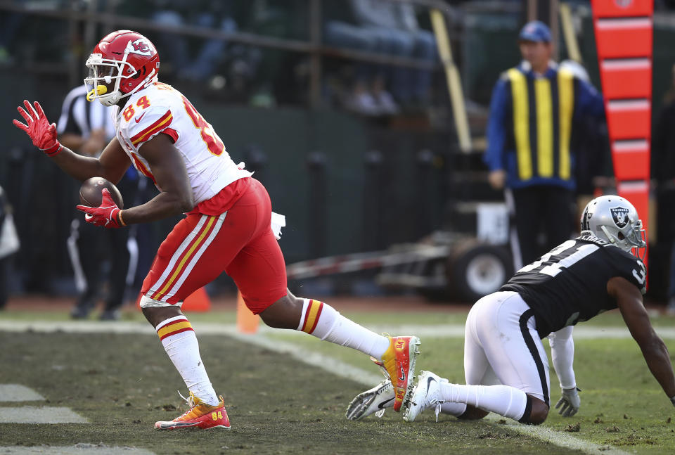 Kansas City Chiefs tight end Demetrius Harris (84) reacts after scoring past Oakland Raiders defensive back Marcus Gilchrist (31) during the second half of an NFL football game in Oakland, Calif., Sunday, Dec. 2, 2018. (AP Photo/Ben Margot)