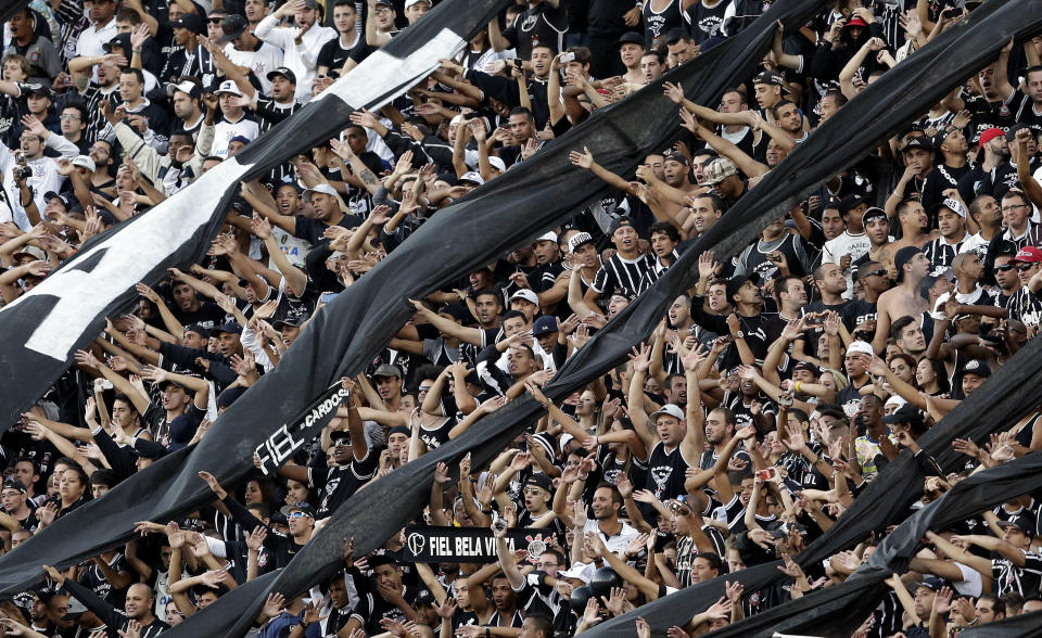 Corinthians' supporters cheer during a Brazilian soccer league match against Flamengo in Sao Paulo, Brazil, Sunday, April 27, 2014. (AP Photo/Andre Penner)