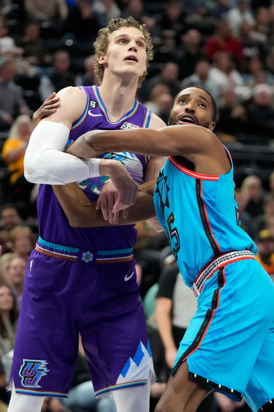 Phoenix Suns forward Mikal Bridges (25) guards Utah Jazz forward Lauri Markkanen during the first half of an NBA basketball game Friday, Nov. 18, 2022, in Salt Lake City. (AP Photo/Rick Bowmer)