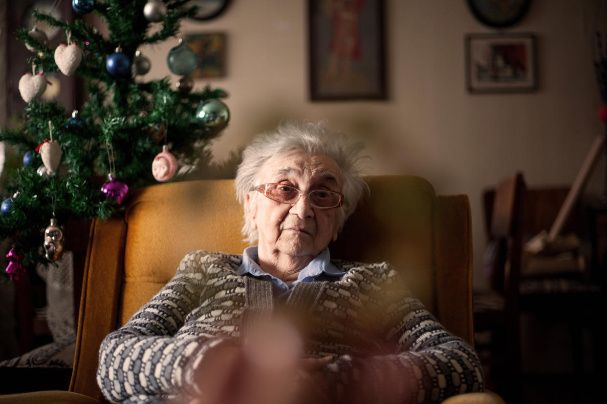 Loneliness: older woman feeling depressed and alone on Christmas .