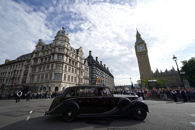 King Charles III and the Queen Consort pass the The Elizabeth Tower, also known as Big Ben, on their journey to Westminster Hall