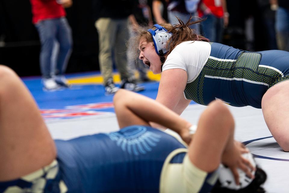 Poudre School District's Mariah Gonzalez drops to the mat and screams in joy after winning her match at the Colorado state wrestling tournament at Ball Arena in Denver on Saturday.