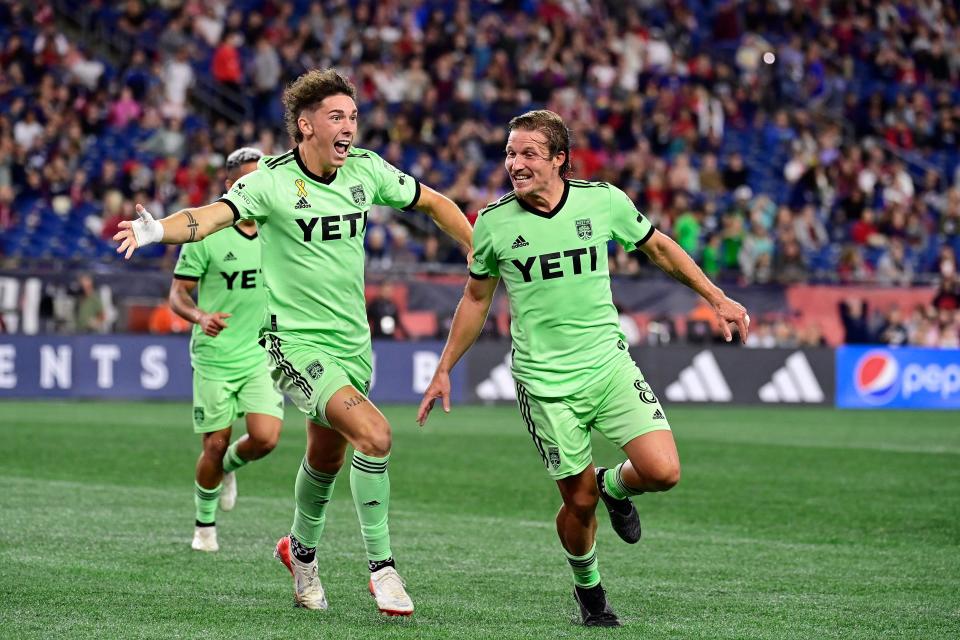 Austin FC forward CJ Fodrey, left, and midfielder Alex Ring celebrate Ring's game-tying goal against the New England Revolution in extra time Saturday night, resulting in a 2-2 draw.