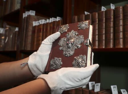 A copy of "The Tales of Beedle the Bard", handwritten and illustrated by Harry Potter author JK Rowling, is displayed at Sotheby's auction house in London, Britain December 8, 2016. REUTERS/Eddie Keogh