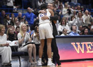 Connecticut head coach Geno Auriemma embraces Connecticut's Napheesa Collier after Collier comes out of the game during the second half of an NCAA college basketball game against South Carolina, Monday, Feb. 11, 2019, in Hartford, Conn. (AP Photo/Jessica Hill)