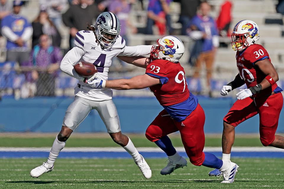 Kansas State wide receiver Malik Knowles (4) is tackled by Kansas defensive lineman Sam Burt (93) during the first half of a game on Nov. 6, 2021, in Lawrence.