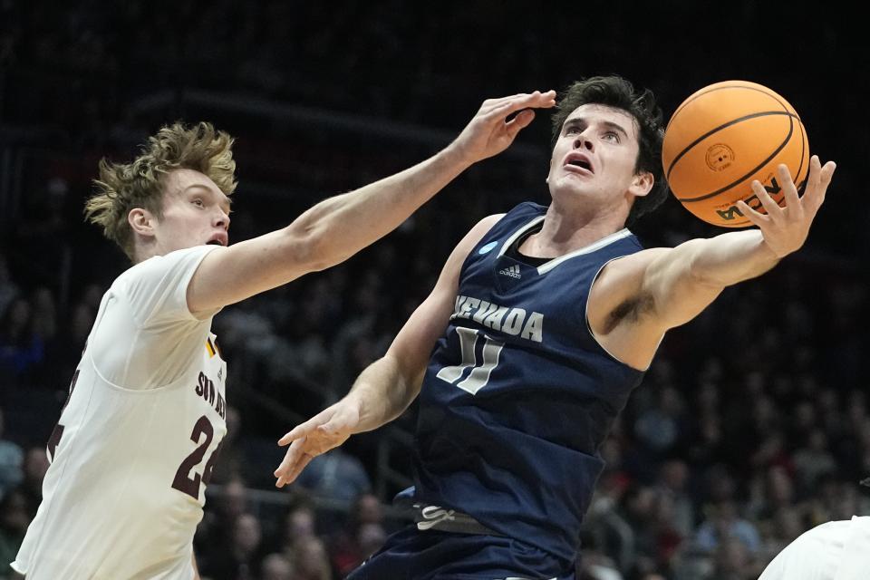 Nevada's Nick Davidson shoots against Arizona State's Duke Brennan during the first half of a First Four college basketball game in the NCAA men's basketball tournament, Wednesday, March 15, 2023, in Dayton, Ohio. (AP Photo/Darron Cummings)