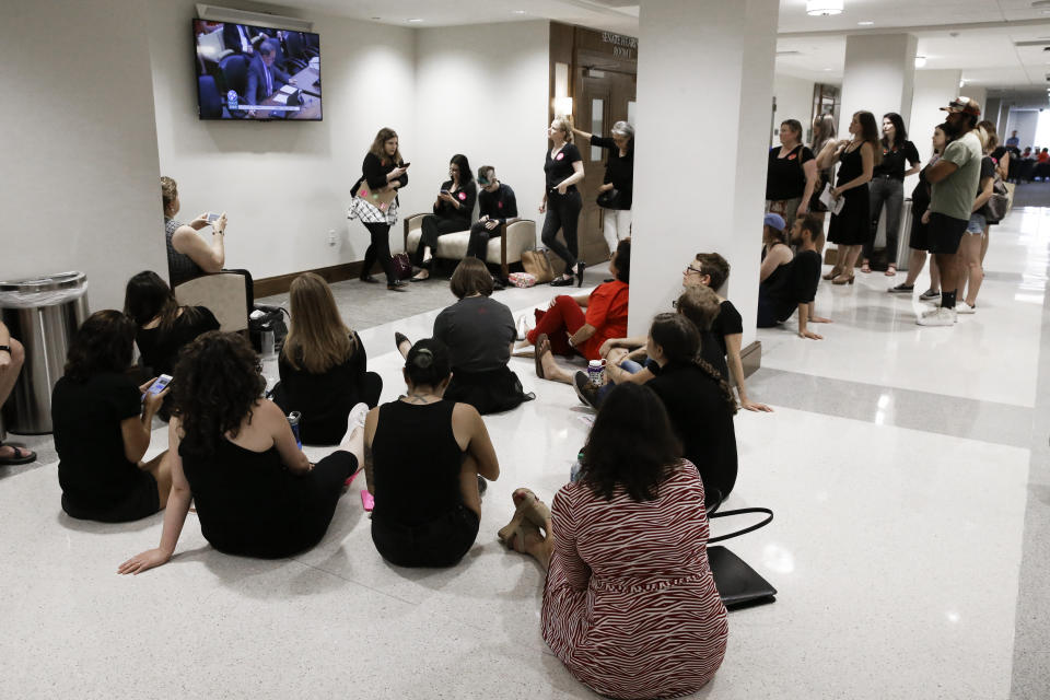 Part of an overflow crowd watches the broadcast of a Senate hearing to discuss a fetal heartbeat abortion ban, or possibly something more restrictive, Monday, Aug. 12, 2019, in Nashville, Tenn. (AP Photo/Mark Humphrey)