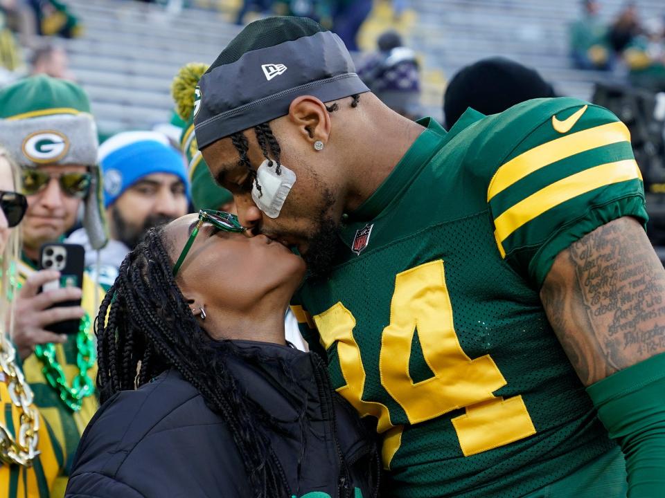 Jonathan Owens #34 of the Green Bay Packers kisses wife Simone Biles before the game against the Los Angeles Chargers at Lambeau Field on November 19, 2023 in Green Bay, Wisconsin
