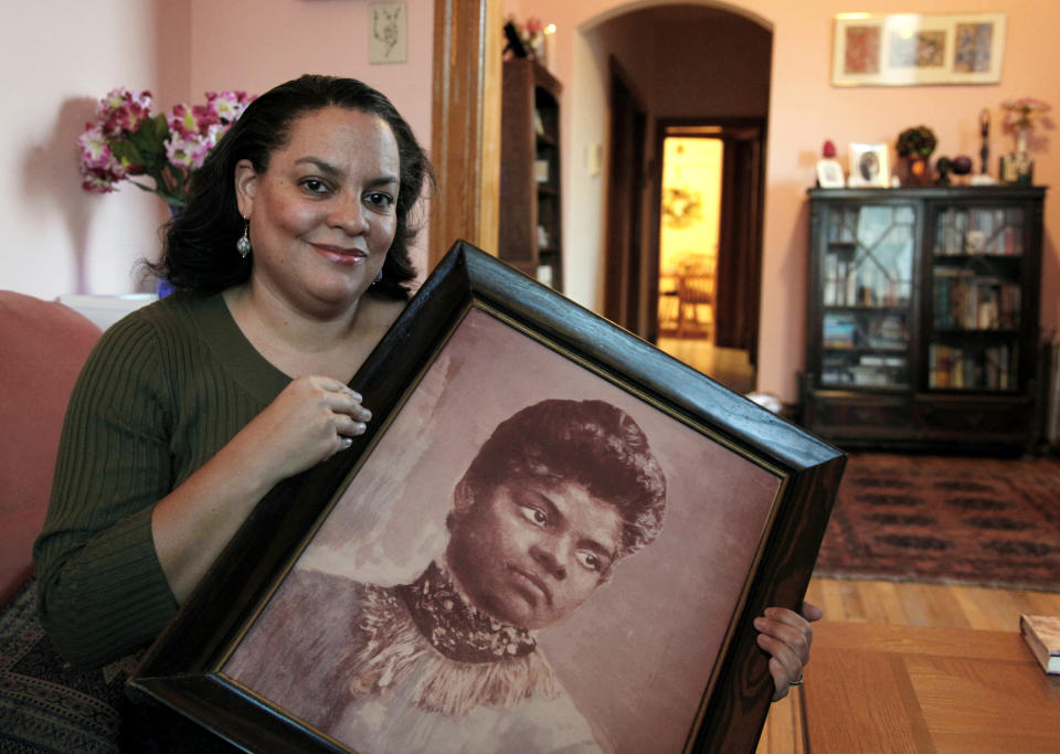 Michelle Duster, great-granddaughter of the civil rights pioneer, holds a portrait of Wells in her home in Chicago's South Side on Dec. 2, 2011. (Photo: CHARLES REX ARBOGAST/ASSOCIATED PRESS)