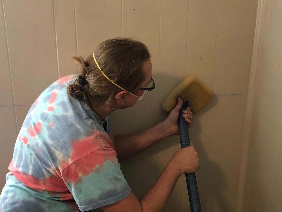 A Tioga Opportunities employee insulates the walls of a home at 125 West St. in Johnson City.