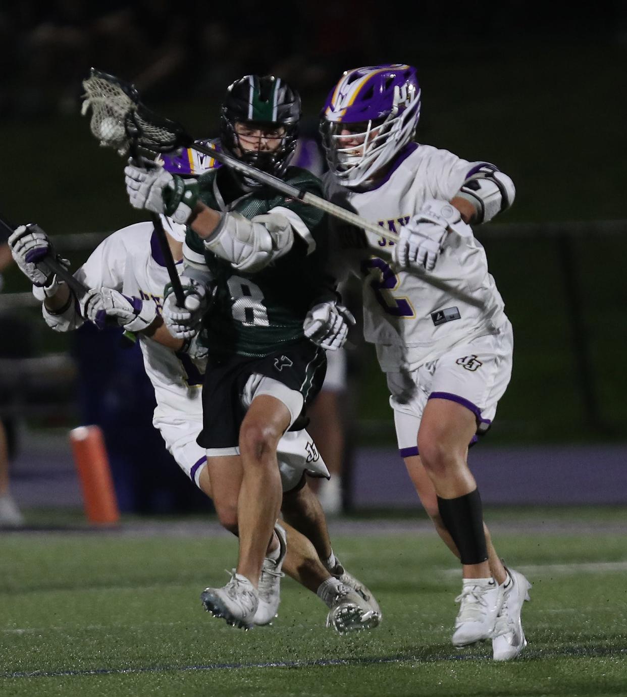 From right, Yorktown's Drew Weissman (8) gets in front of John Jay's Luca Duva (2) during boys lacrosse action at John Jay High School in Cross River April 14, 2023. Yorktown won the game 9-8.