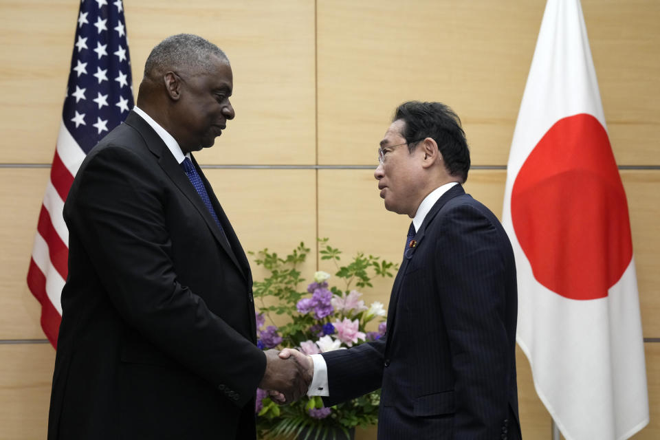 U.S. Defense Secretary Lloyd Austin, left, and Japanese Prime Minister Fumio Kishida shake hands prior to their meeting at the prime minister's office in Tokyo Thursday, June 1, 2023. (AP Photo/Eugene Hoshiko, Pool)