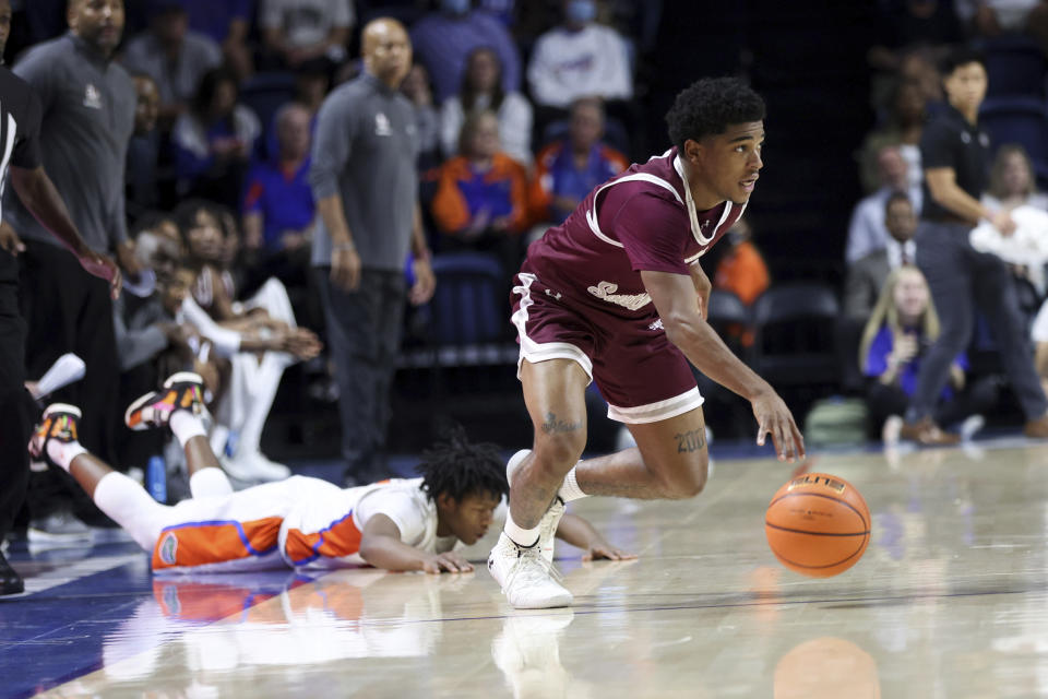 Texas Southern guard PJ Henry (3) dribbles upcourt after coming up with the ball against Florida guard Tyree Appleby (22) during the first half of an NCAA college basketball game Monday, Dec. 6, 2021, in Gainesville, Fla. (AP Photo/Matt Stamey)