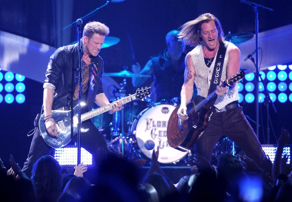 FILE - in this Dec. 10, 2013 file photo, Brian Kelley, left, and Tyler Hubbard, of musical group Florida Georgia Line, perform at the American Country Awards at the Mandalay Bay Resort & Casino, in Las Vegas. The first iHeartRadio Country Festival will be held March 29, 2014, in Austin, Texas, with Luke Bryan, Jason Aldean, Eric Church, Carrie Underwood, Lady Antebellum and Florida Georgia Line heading up the initial lineup. (Photo by Frank Micelotta/Invision/AP, File)