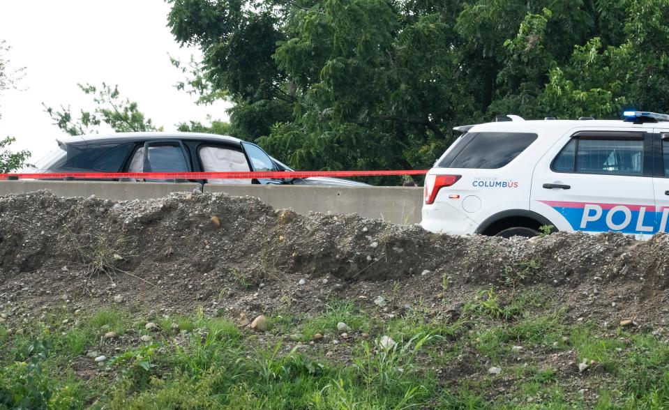 Jul 6, 2023; Columbus, Ohio, USA;  Officers investigate and mark the crime scene on I70 where a car crash occurred following a bank robbery and car theft. 