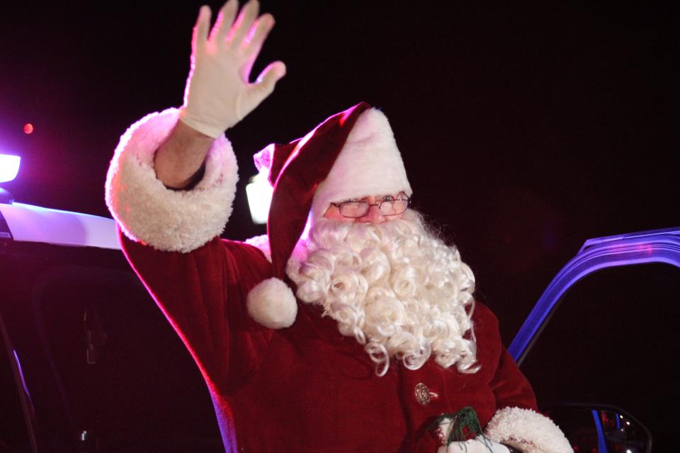 Santa greets children at the 2021 Olsen Christmas Wish event.