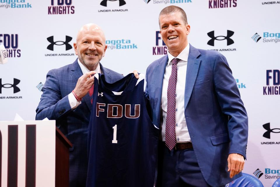 (from left) Bradford Hurlbut, director of athletics for Fairleigh Dickinson University, and Tobin Anderson, the new men's basketball head coach, pose for a photo during a press conference on Thursday, May 5, 2022, in Hackensack.