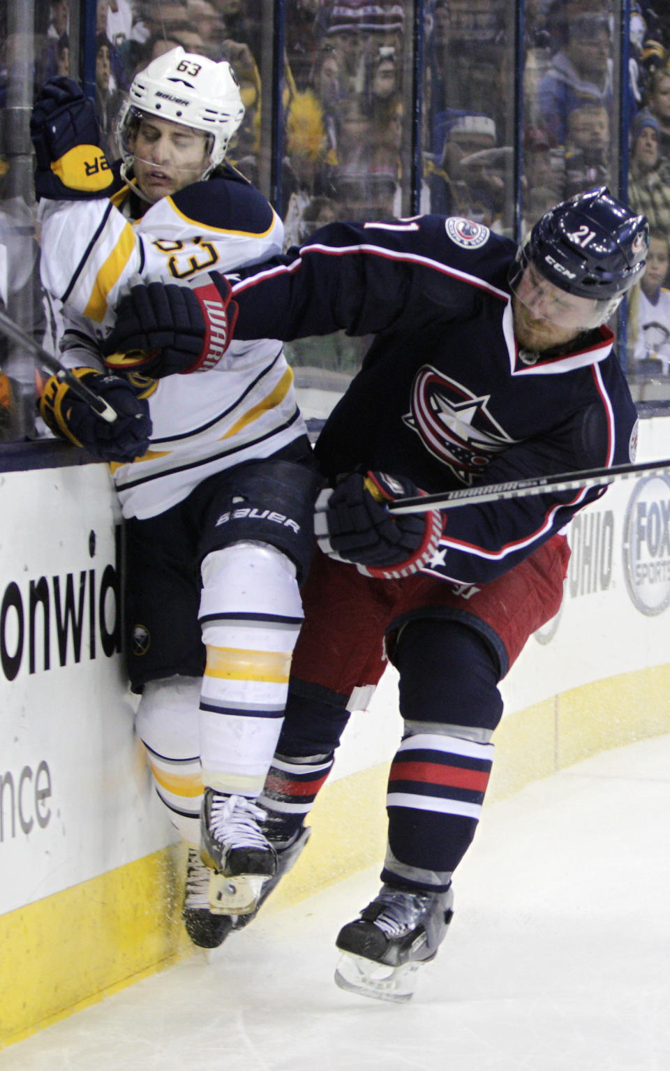 Columbus Blue Jackets' James Wisniewski, right, checks Buffalo Sabres' Tyler Ennis during the first period of an NHL hockey game, Saturday, Jan. 25, 2014, in Columbus, Ohio. (AP Photo/Jay LaPrete)