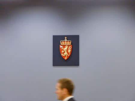 Fredrik Sejersted, NorwayÕs Attorney General, passes underneath the symbol of the Norwegian state in a courtroom in the district court in Oslo, Norway November 14, 2017. REUTERS/Gwladys Fouche