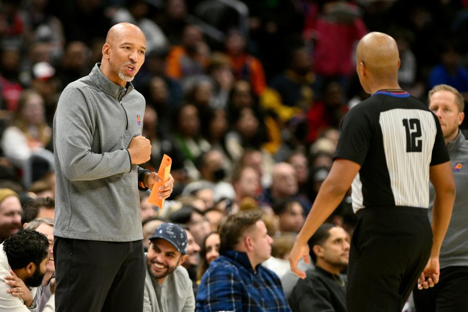 Phoenix Suns head coach Monty Williams, left, reacts to referee CJ Washington (12) during the first half of an NBA basketball game against the Washington Wizards, Wednesday, Dec. 28, 2022, in Washington. (AP Photo/Nick Wass)