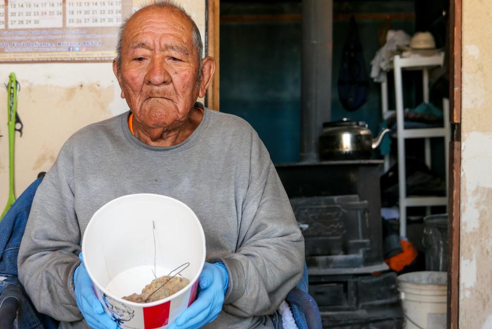 Bob Begay, 85, a former uranium miner who suffers from idiopathic pulmonary fibrosis, displays two keepsake chunks of radioactive ore in his home on the Navajo reservation in Rough Rock, Arizona.