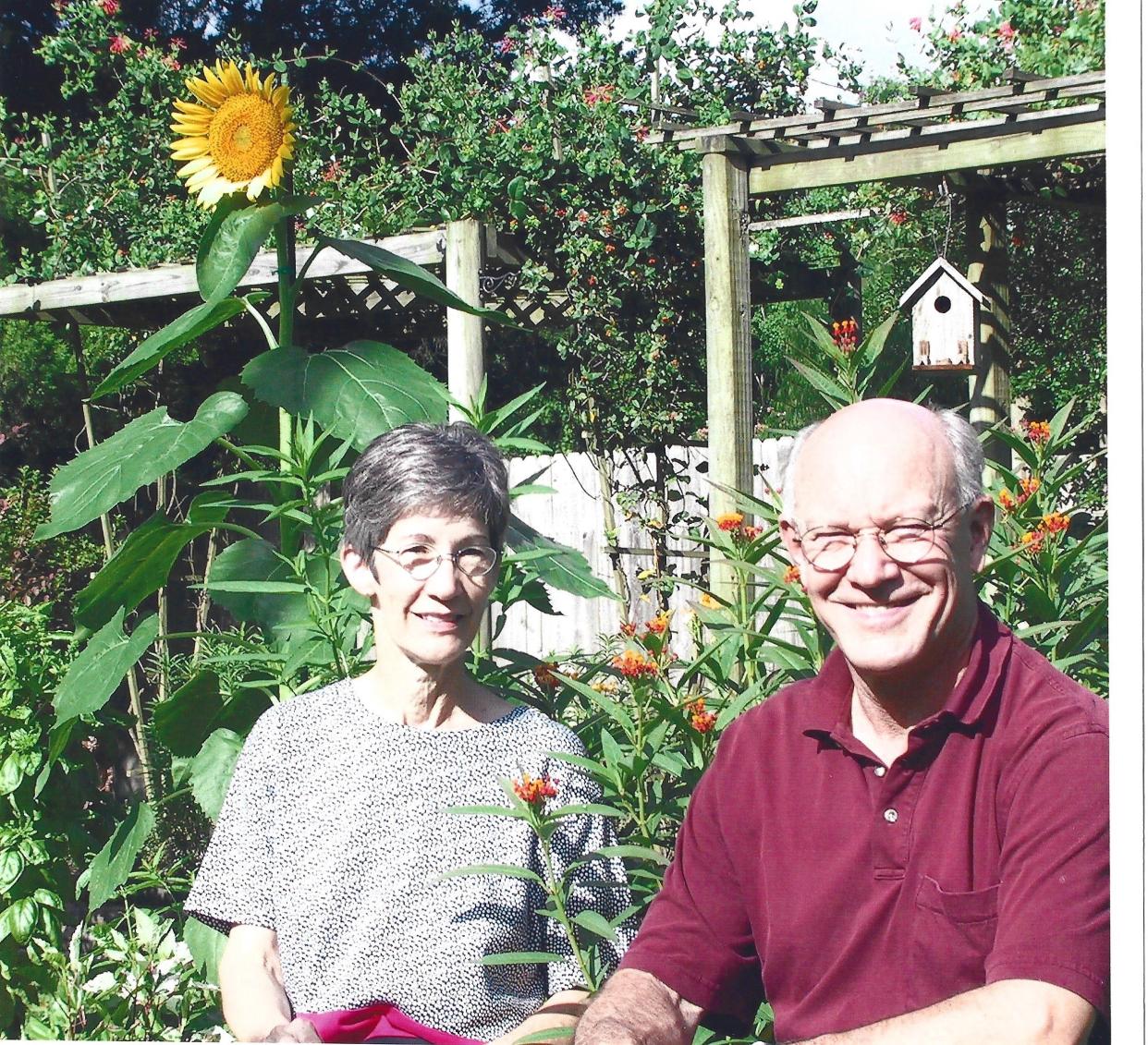 Lauren and Sherman Young in their once-lush yard before the hurricanes destroyed most of the garden.