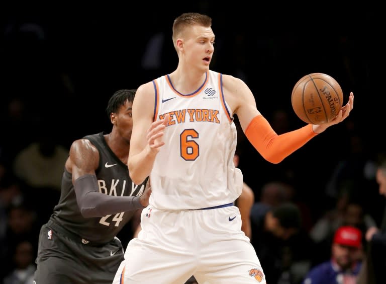 Kristaps Porzingis of the New York Knicks grabs the ball as Rondae Hollis-Jefferson of the Brooklyn Nets defends, at the Barclays Center in New York, on December 14, 2017