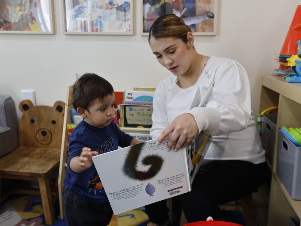 Jennifer Cortez reads to a toddler.