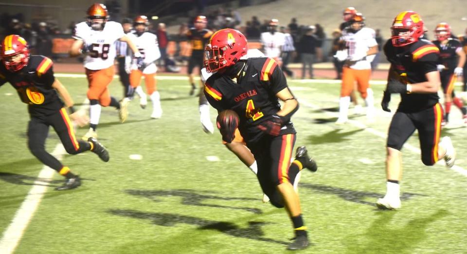 Oakdale High School junior Joseph Delte (4) runs for a touchdown during the Mustangs’ 56-35 playoff win over Merced on Friday, Nov. 11, 2023.